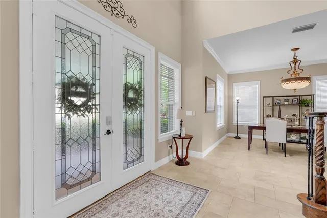 a dining room with wooden floor a chandelier a wooden table and chairs
