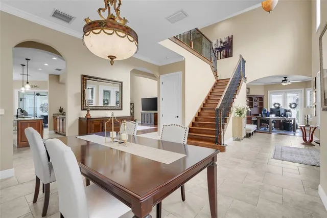 a living room with furniture a clock on wall and a table