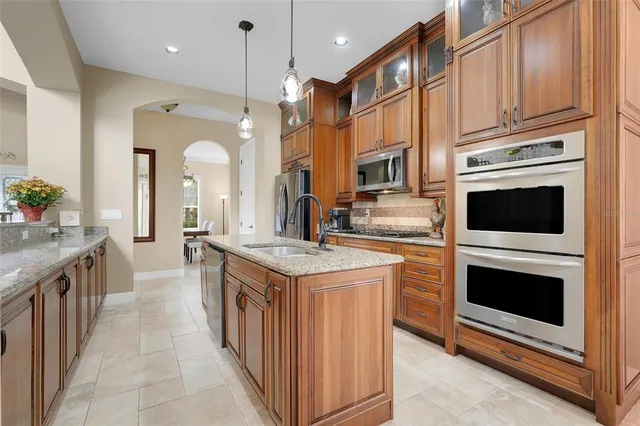 a view of a dining room with furniture and a chandelier