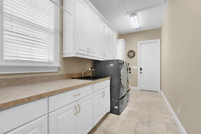 a spacious bathroom with a granite countertop tub sink and mirror