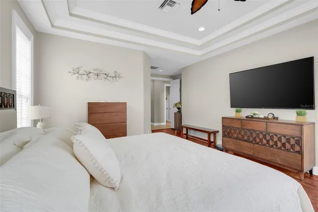 a view of a hallway with wooden floor and windows