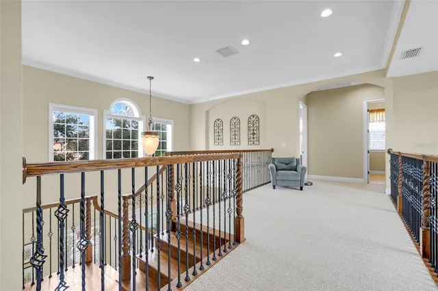 a bedroom with a bed a couch and a flat screen tv