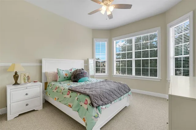 a view of pool with a table and chairs under an umbrella