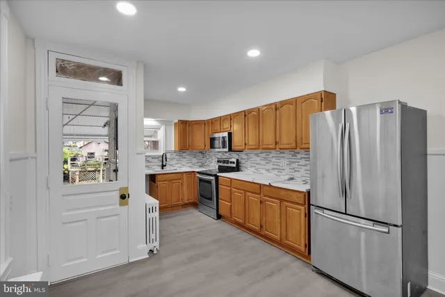 a kitchen with stainless steel appliances granite countertop a sink stove and microwave