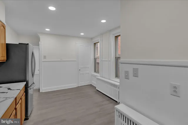 a kitchen with stainless steel appliances a refrigerator and cabinets
