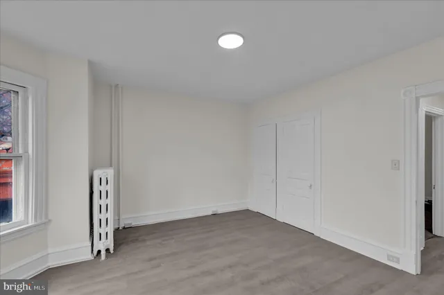 a view of an empty room and closet area