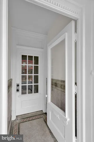 a view of a hallway with wooden floor and stairs