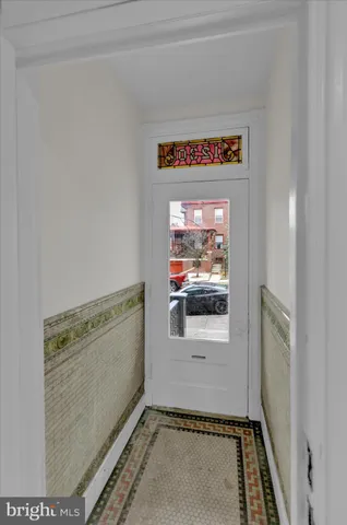 an empty room with wooden floor and a fireplace