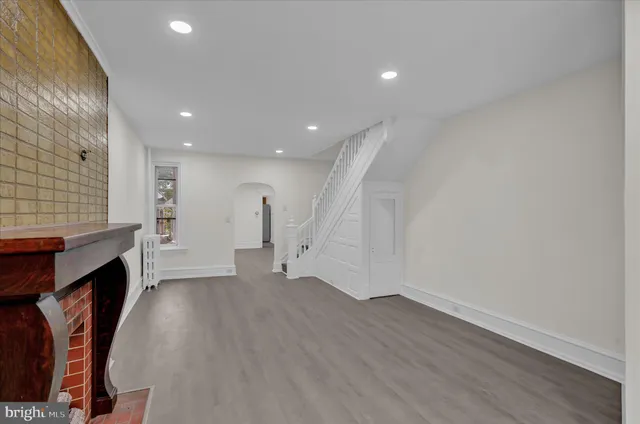 a view of an empty room with a fireplace