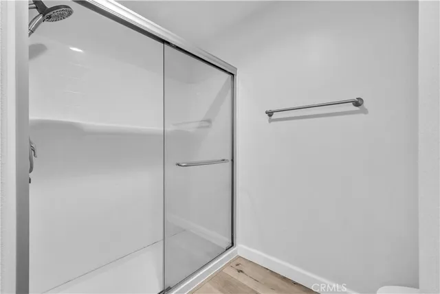 a bathroom with a glass shower door