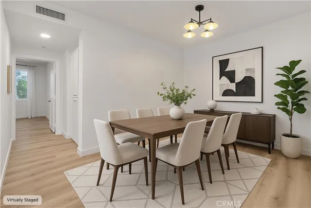 a view of a dining room with furniture wooden floor and a chandelier