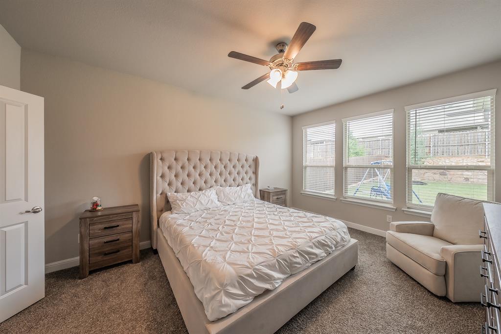 1212 Bosque Lane Weatherford, TX 76087 - Photo 24 of 38 a bedroom with a large bed and a chandelier