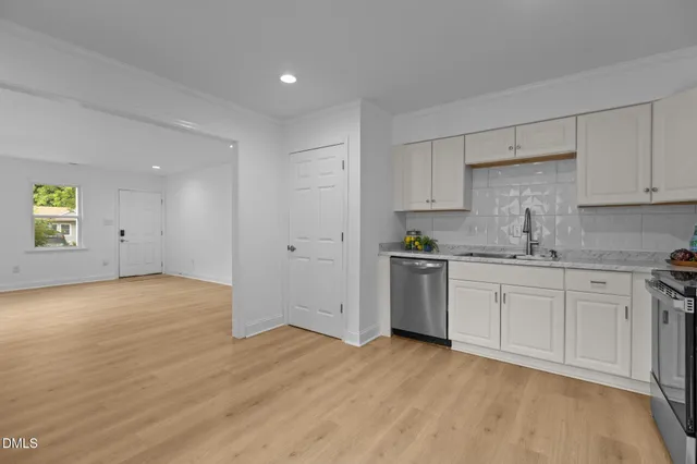 a kitchen with granite countertop white cabinets and white appliances
