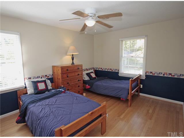 5404 Christman Court Raleigh, NC 27609 - Photo 13 of 20 a bedroom with a bed and window