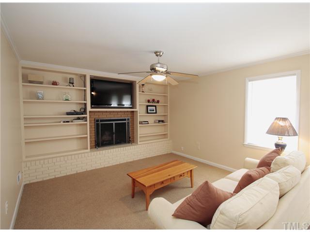 5404 Christman Court Raleigh, NC 27609 - Photo 16 of 20 a living room with furniture a flat screen tv and a fireplace