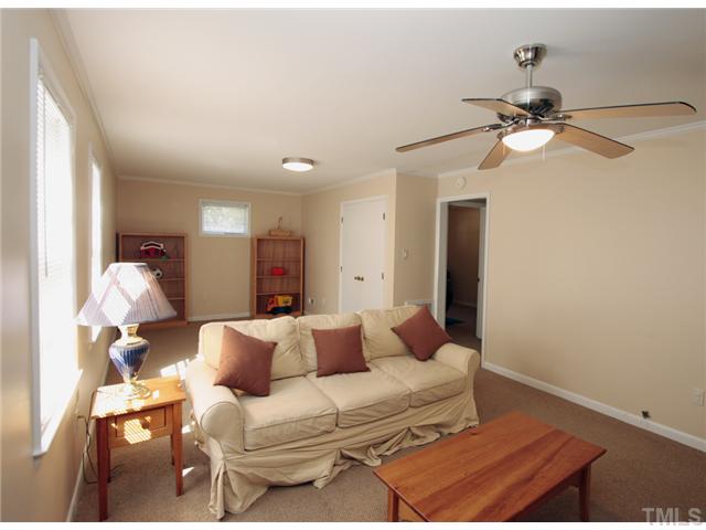 5404 Christman Court Raleigh, NC 27609 - Photo 17 of 20 a bedroom with a bed and a chandelier