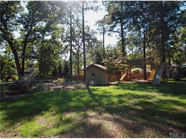 5404 Christman Court Raleigh, NC 27609 - Photo 20 of 20 a backyard of a house with table and chairs plants and trees