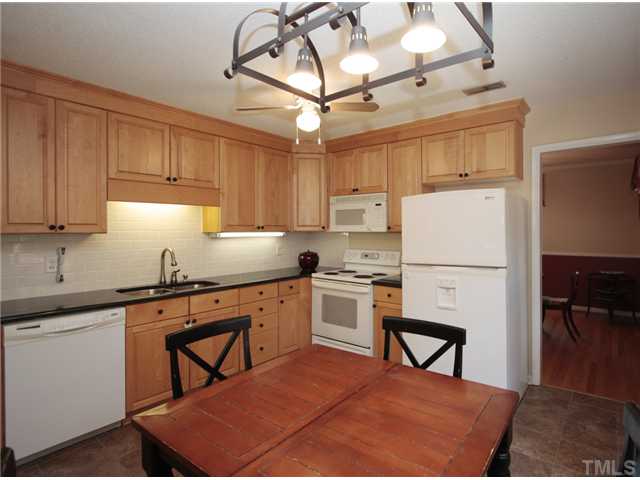 5404 Christman Court Raleigh, NC 27609 - Photo 7 of 20 a kitchen with appliances cabinets and furniture