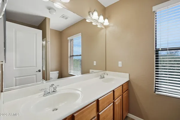 a bathroom with a double vanity sink and a mirror