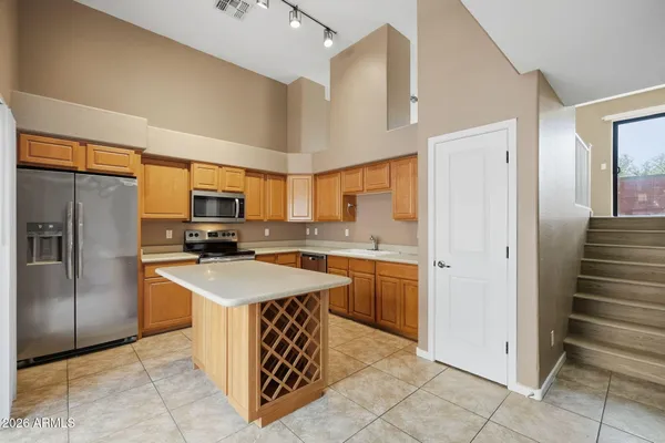 a kitchen with stainless steel appliances granite countertop a sink counter space cabinets and stainless steel appliances