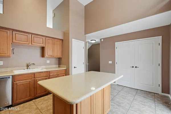 a kitchen with a sink a cabinets and window