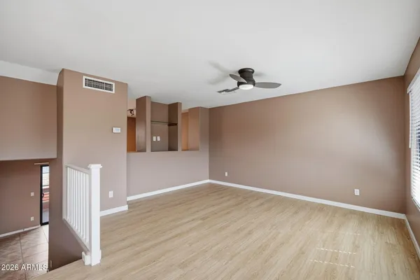 a view of empty room with wooden floor