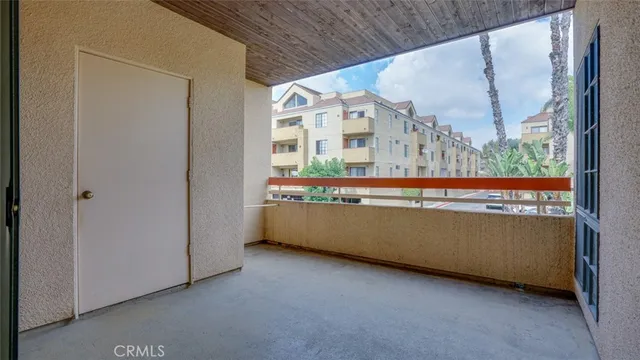 a view of a yard with plants and a large tree