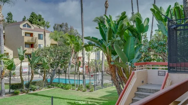 a view of an empty room with closet and a window