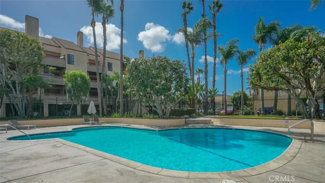 a view of road with card and parked cars