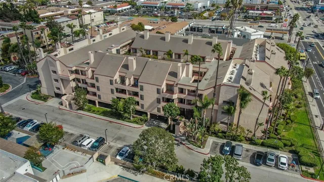an aerial view of multiple houses with yard