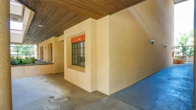a balcony with window and flowers