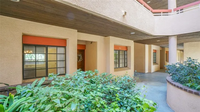 a view of a hallway with a door and wooden door