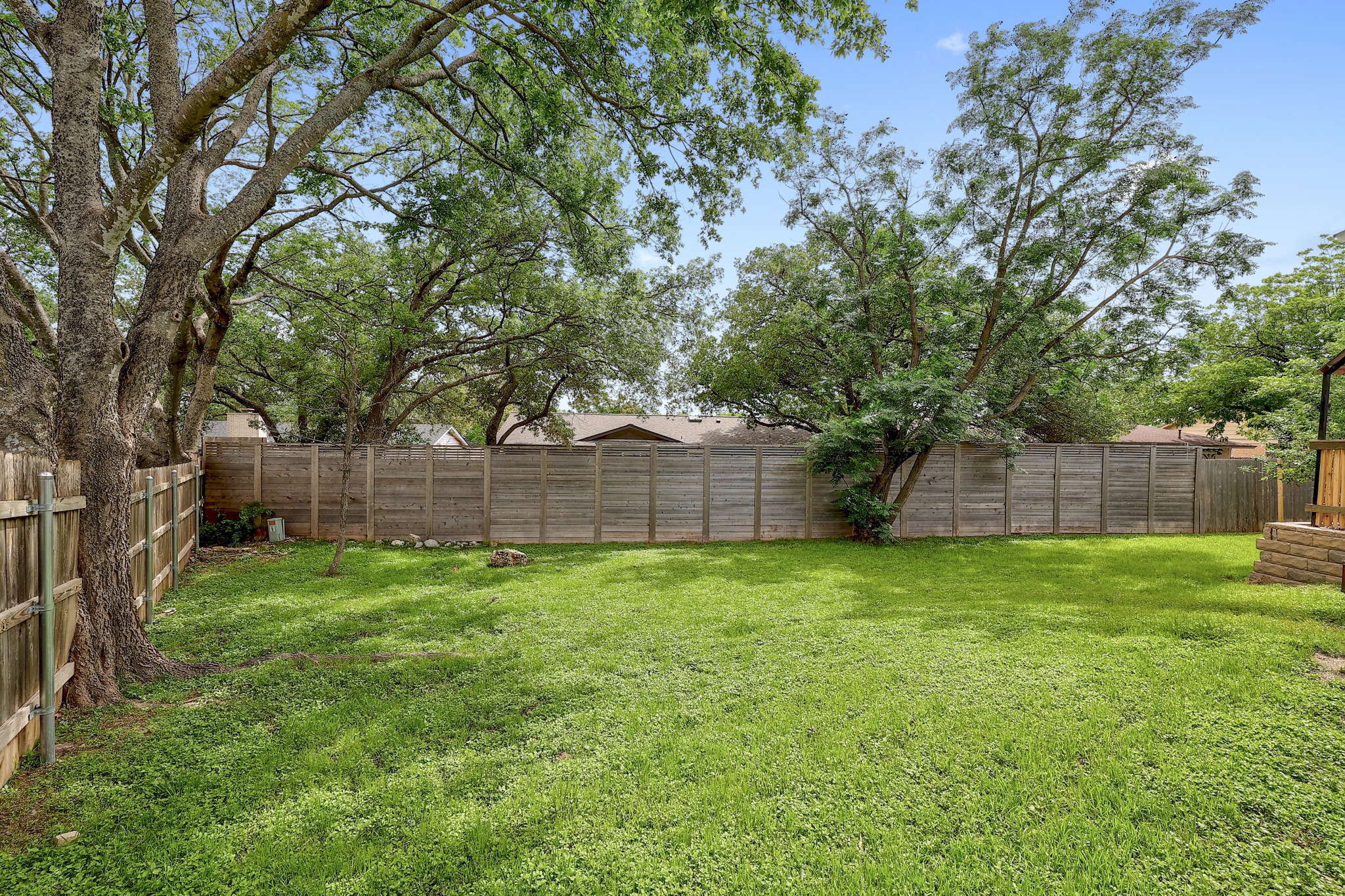 9614 Chukar Circle Austin, TX 78758 - Photo 24 of 26 Trees line the fence providing shade throughout the day.