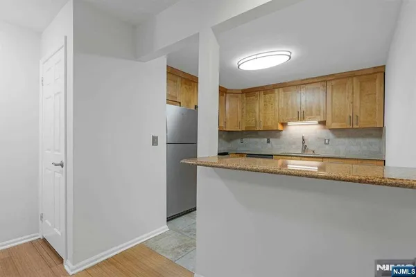 a view of a kitchen cabinets a sink and wooden floor