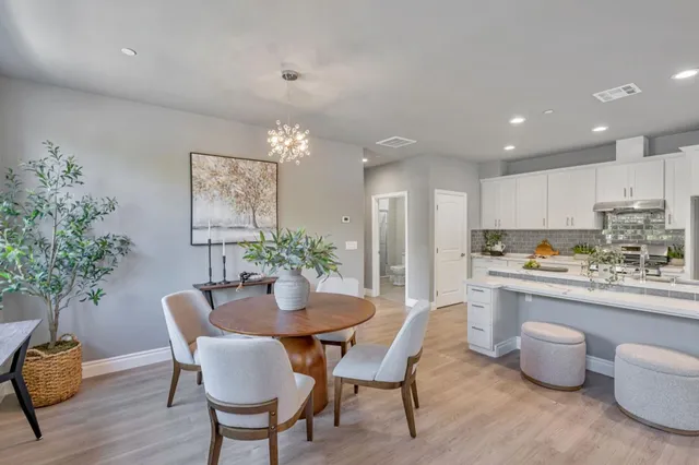 a kitchen with a table and chairs in it