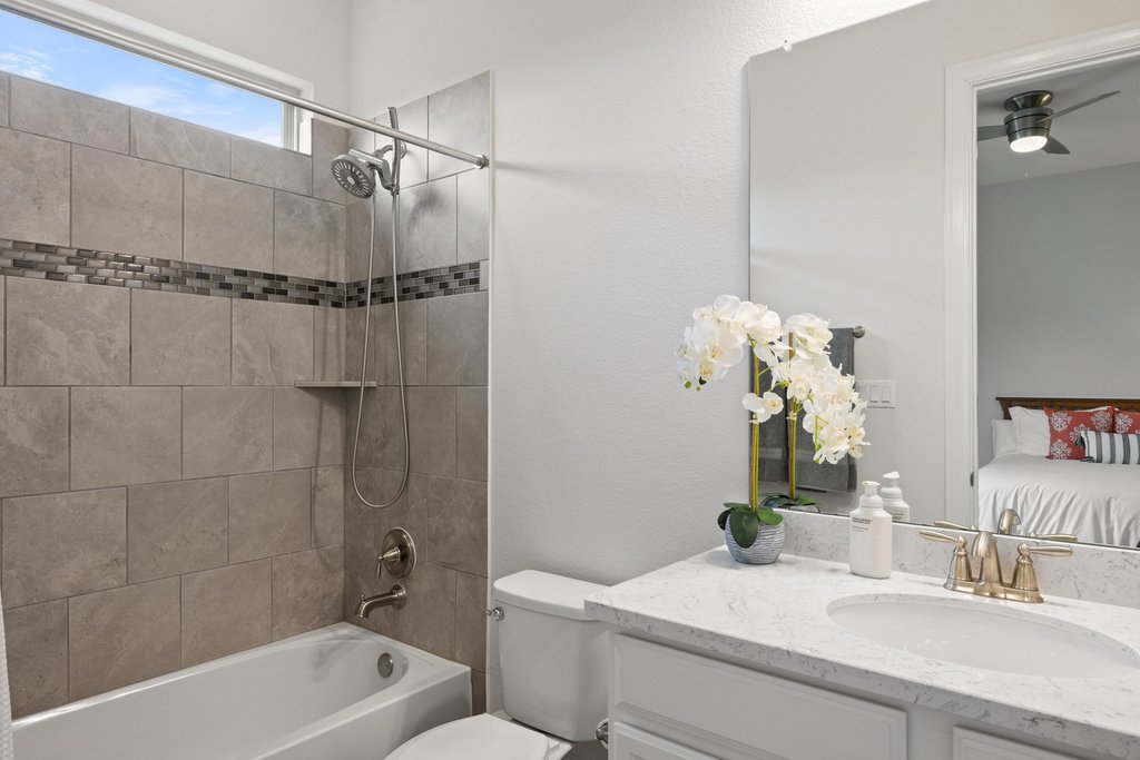 215 Lodestone Lane Austin, TX 78738 - Photo 26 of 40 Elegant quartz counters and sleek fixtures adorn this well-appointed bath.