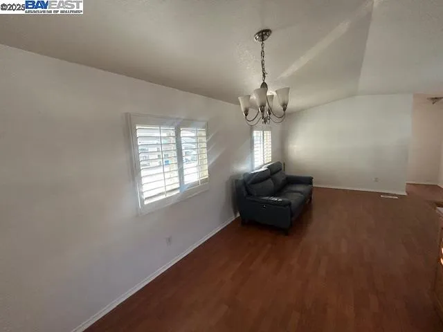 a living room with hard wood floors and a window