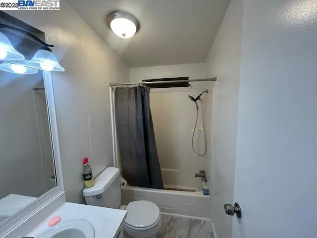 a bathroom with a shower and toilet