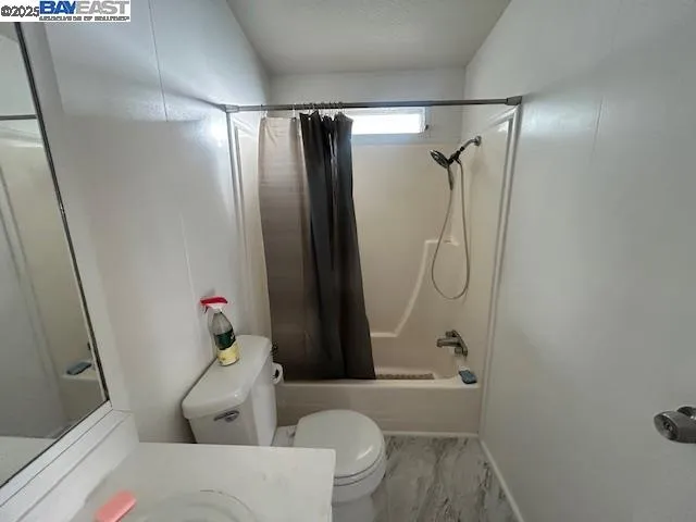 a bathroom with a tub and shower