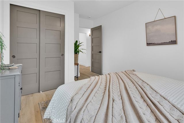 a bedroom with a bed and a mirror