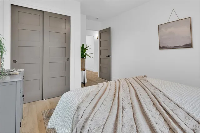 a bedroom with a bed and a mirror