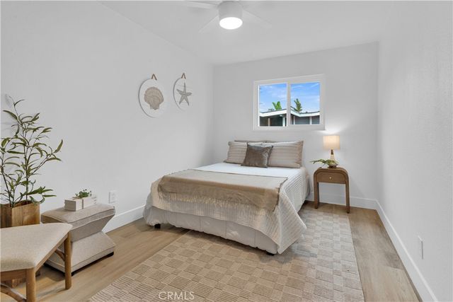 a bedroom with a bed and a potted plant