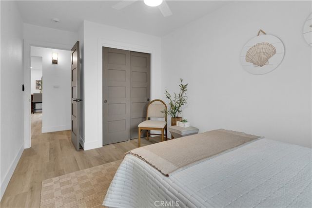 a bedroom with a bed and chandelier