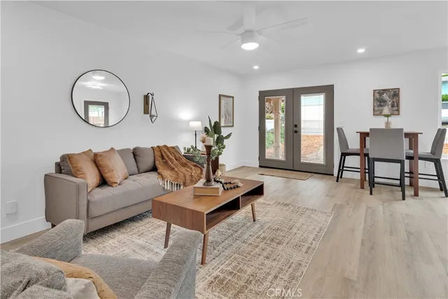 a living room with furniture and wooden floor