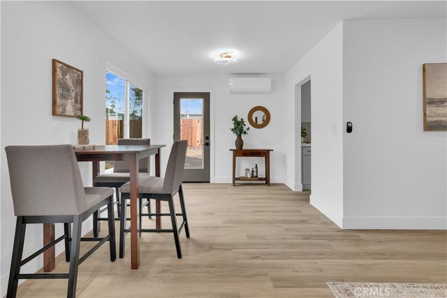 a view of a dining room with furniture and window