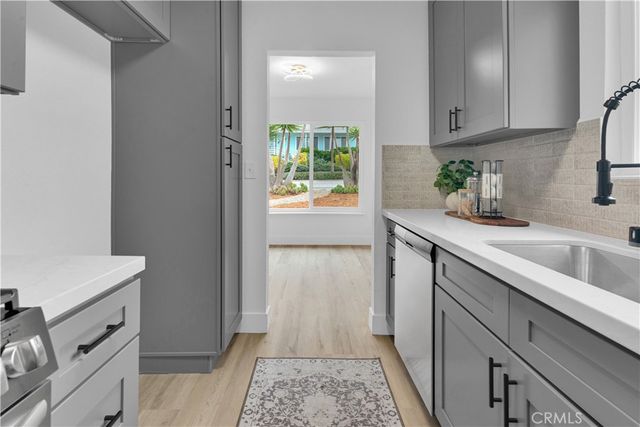 a kitchen with a sink and a refrigerator