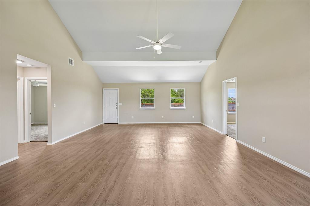 433 Whitney Court Rio Vista, TX 76093 - Photo 8 of 27 an empty room with wooden floor and windows