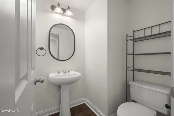 a bathroom with a sink toilet and a mirror