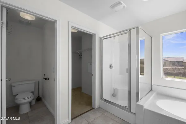 a bathroom with a granite countertop toilet a sink and a mirror