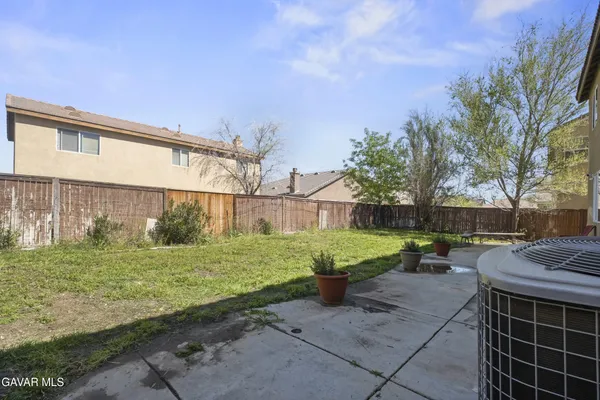 a view of backyard with outdoor seating and green space